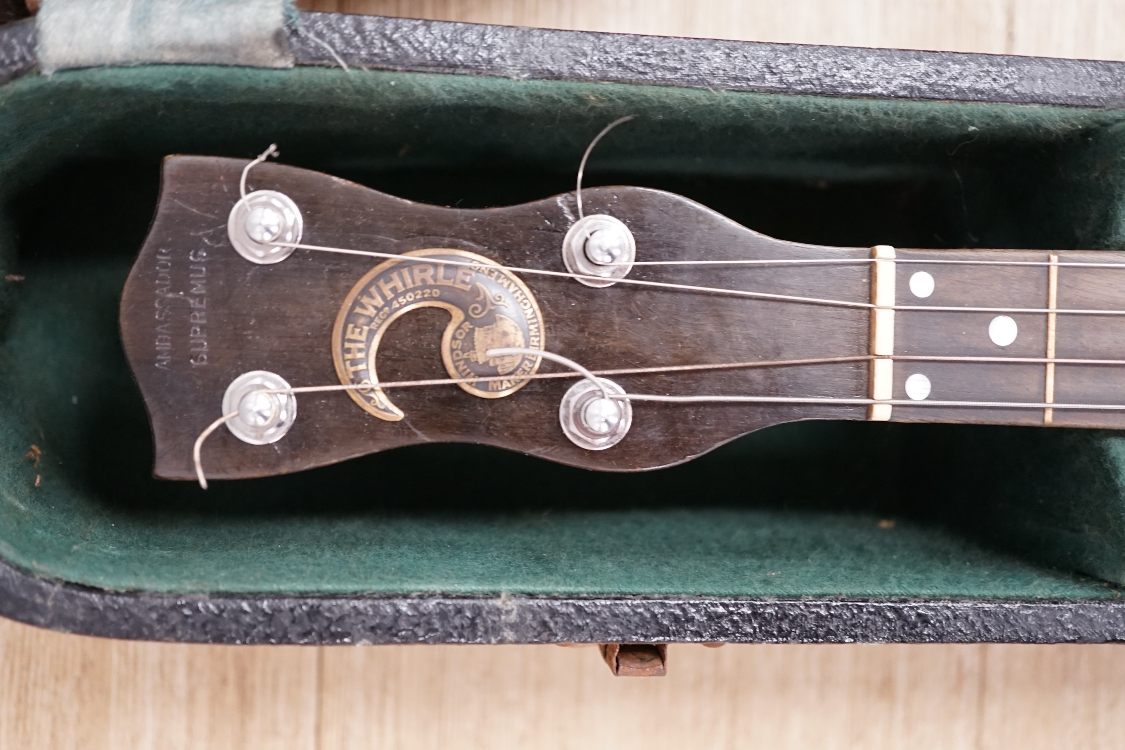 A cased English 1930s Windsor Whirl four string tenor banjo, mother of pearl inlaid neck, length of body 33cm, overall length 84cm, in fitted case